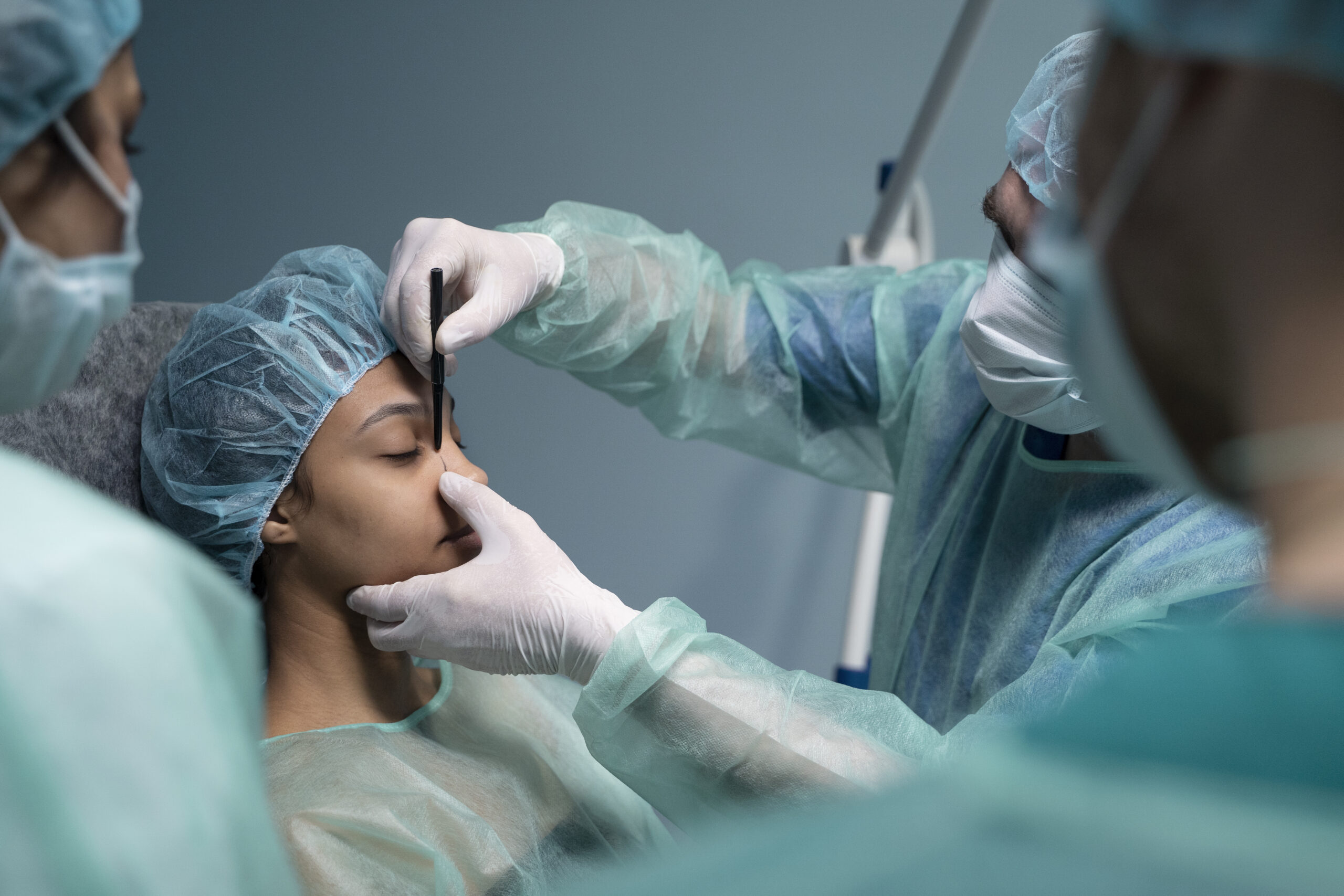side view doctor checking patient before rhinoplasty scaled