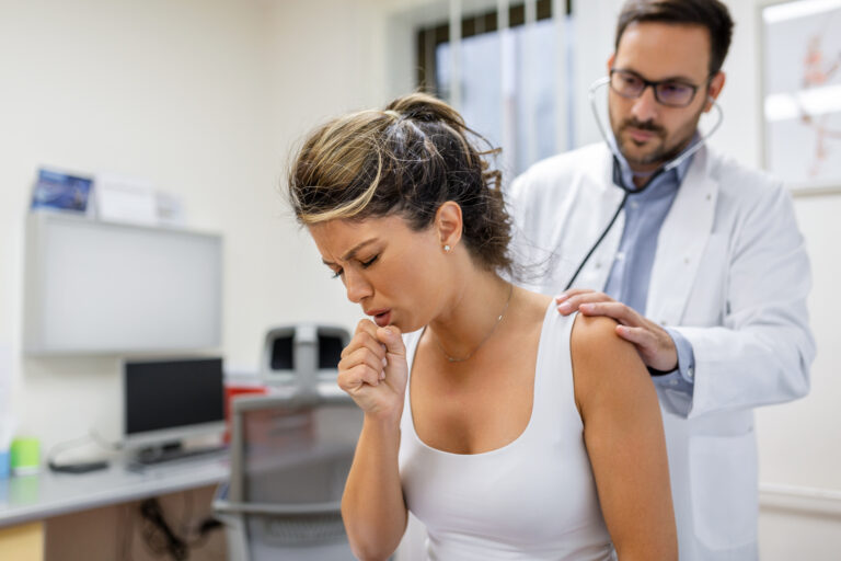 young female patient clinic suffered from pneumonia she is coughing doctor listens wheezing lungs with stethoscope